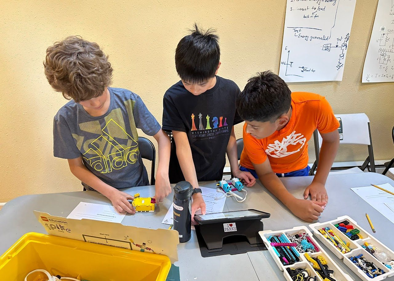 Students building LEGO robots in class
