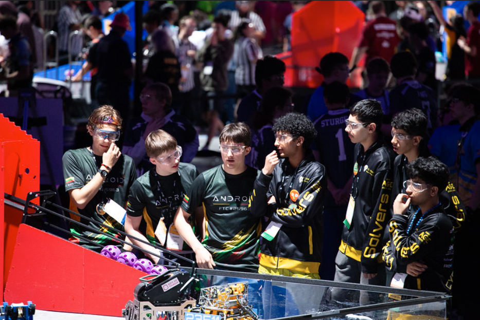 The Seattle Solvers watching a match from the competition pit at Houston